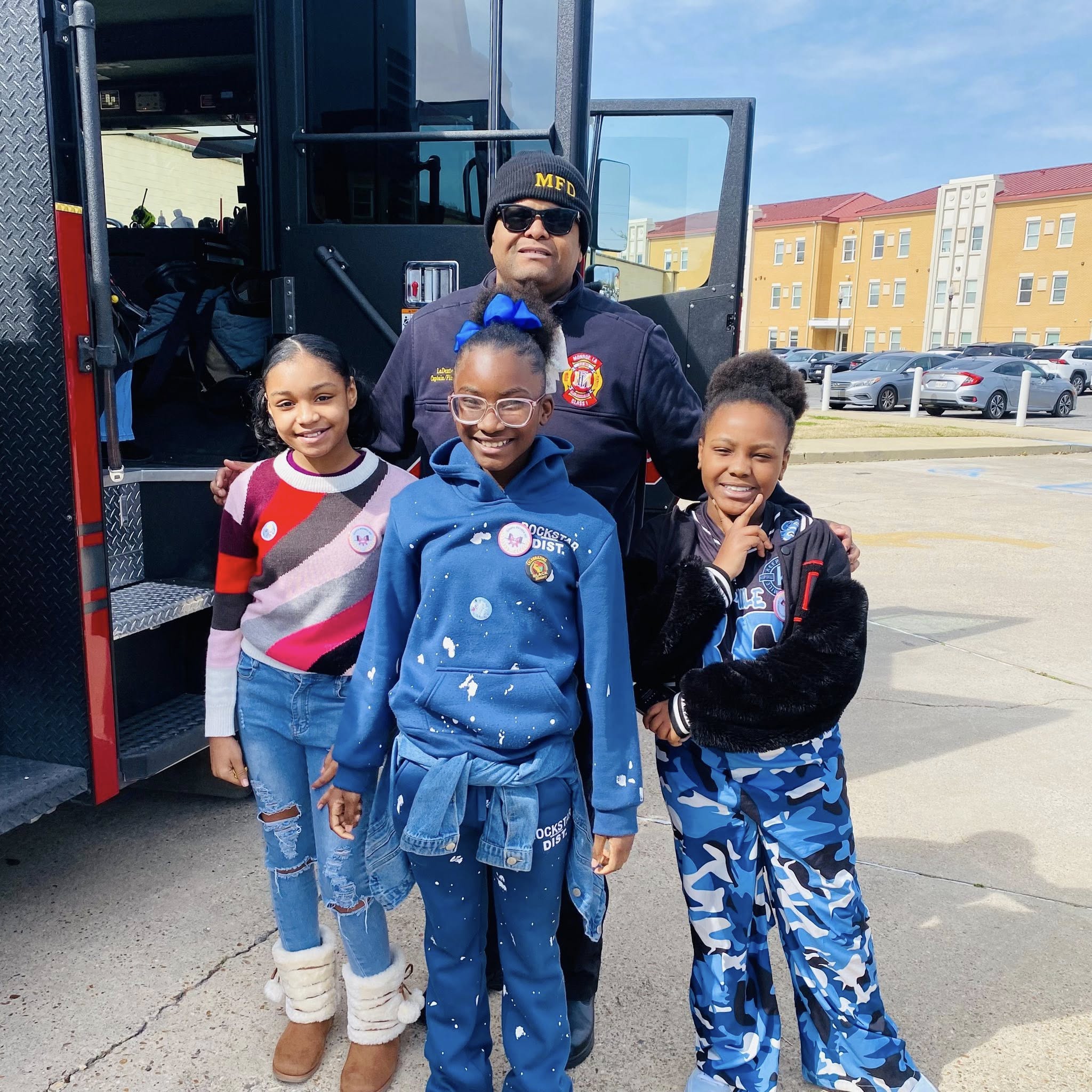 A man and three girls posing for a photo.